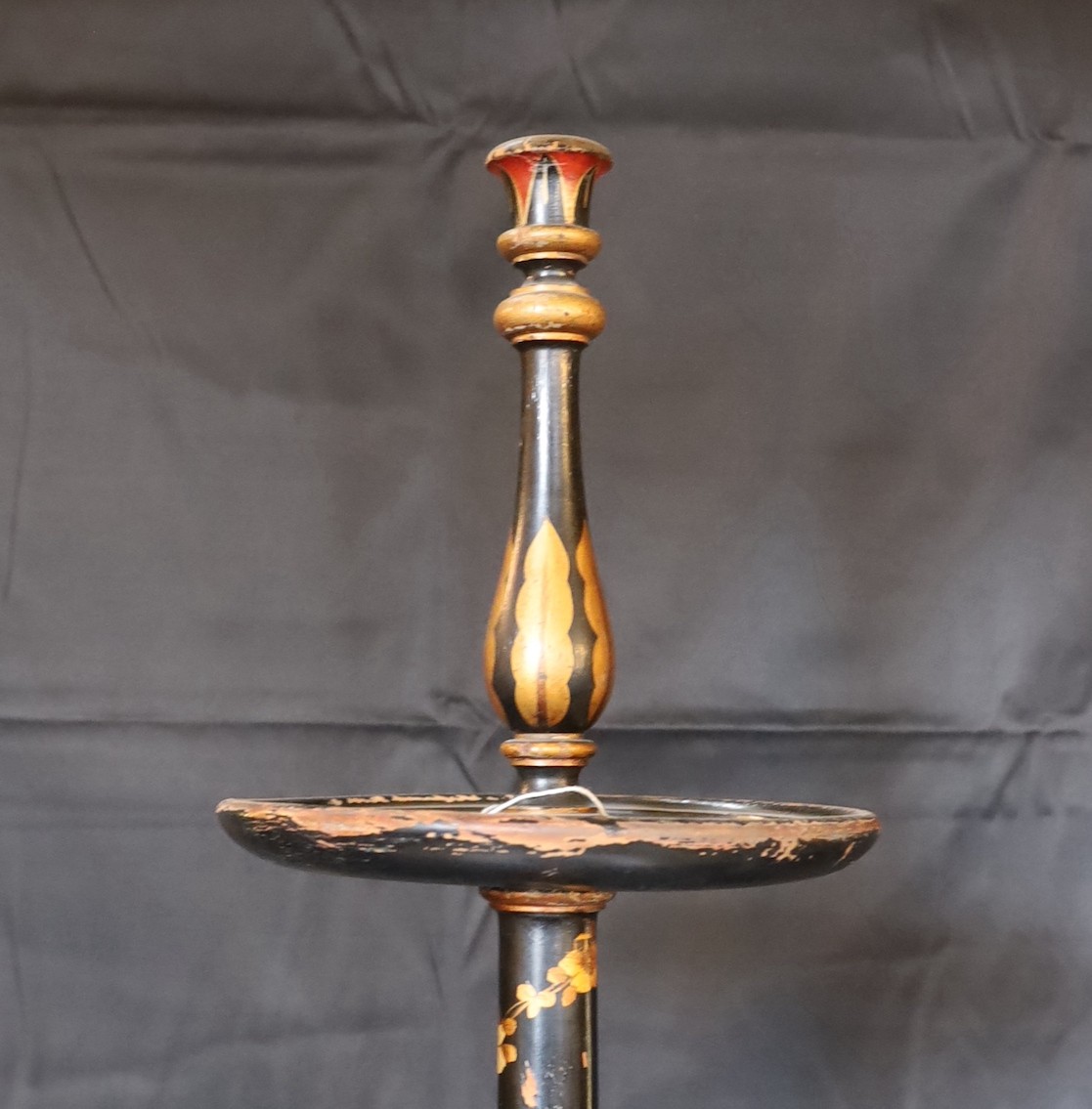A 1920s English chinoiserie lacquered lamp standard, decorated with gilt figures in boats and flowers on a black ground, height 164cm. width of base 38cm